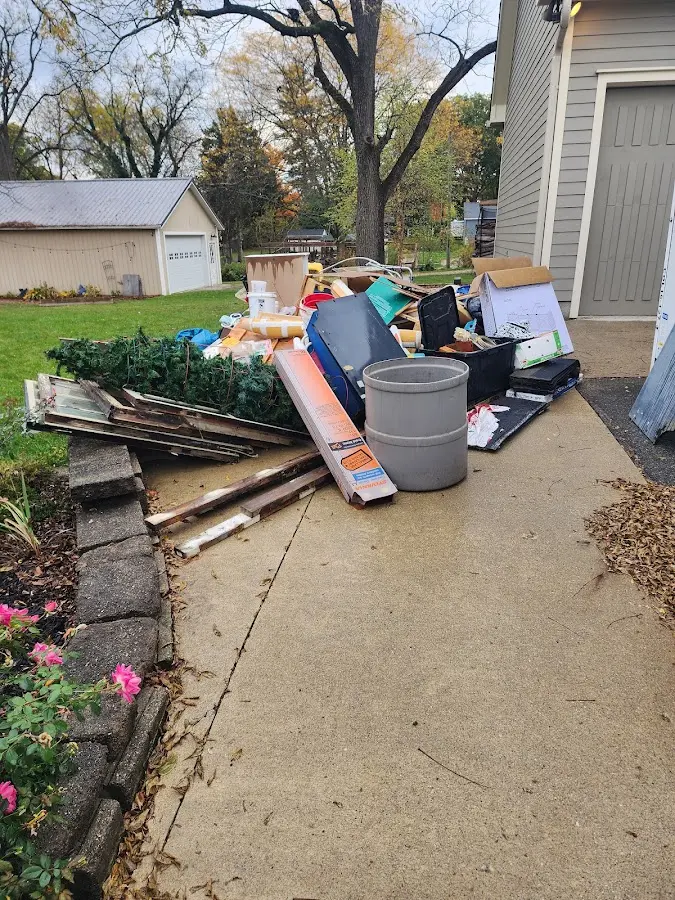 Dumpster being loaded with debris for 12 Yard Dumpster Rental in Leroy